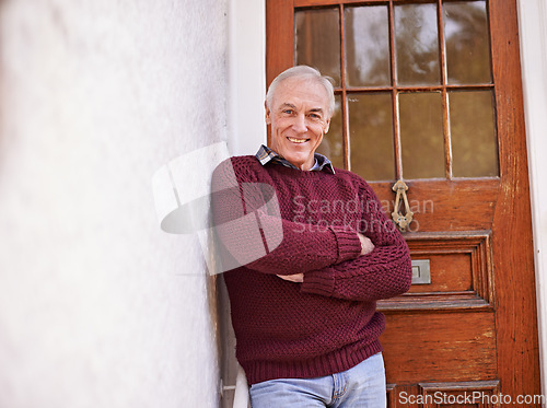 Image of Crossed arms, door and portrait of senior man at his home with positive, good and confident attitude. Happy, pride and elderly person in retirement at wooden entrance of modern house in Australia.