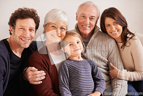 Image of Grandparents, parents and child on couch for portrait with hug, care or love with generations for bonding in home. Mother, father and senior people with kid for embrace on lounge sofa in family house