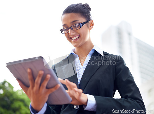 Image of Lawyer, smile or woman with tablet in city for legal research, online app or social media post. Attorney, low angle or happy advocate reading business email, networking or internet article for travel