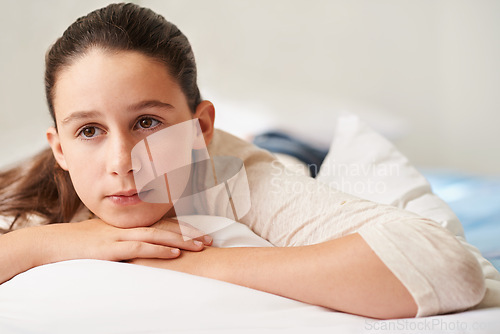 Image of Girl, relax and thinking on bed in home, tired and peace or calm for waking up on weekend. Female person, pillow and comfortable in bedroom for fatigue or contemplating, blanket and ponder for lazy