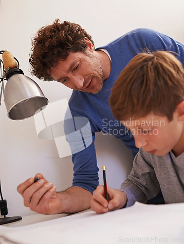 Image of Study, man and father help son with homework for child, growth and development with education. Parent, guy and male person with support for boy, notebook and writing on table for maths exam or test