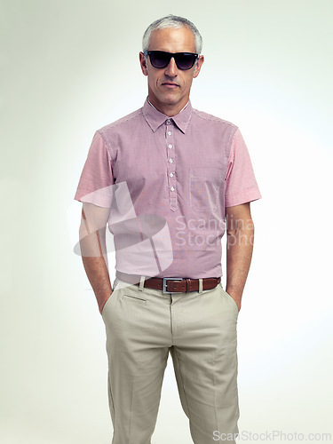 Image of Confident, older or man in business, fashion or stylish outfit and apparel on white background. Businessman, hands in pocket or eyewear as smart, casual or unique leisure wear to relax on getaway