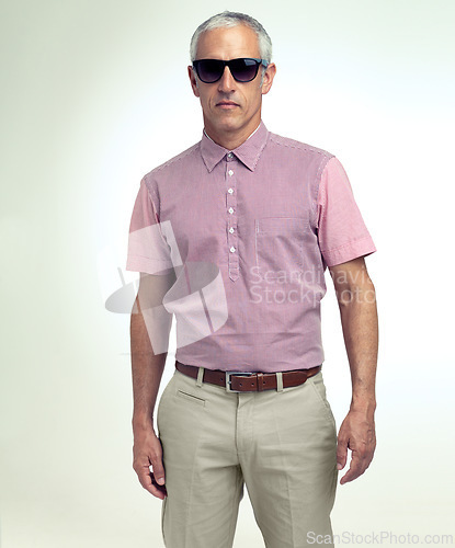 Image of Mature man, confident or trendy as fashion, apparel or stylish outfit in studio on white background. Assertive, businessman or sunglasses as smart, casual or leisure wear to relax on getaway