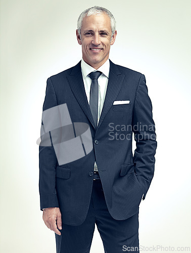 Image of Business man, smile and portrait in studio for professional, career and corporate for job and style indoor. Mature person, trader or executive and happy with suit for confidence and work