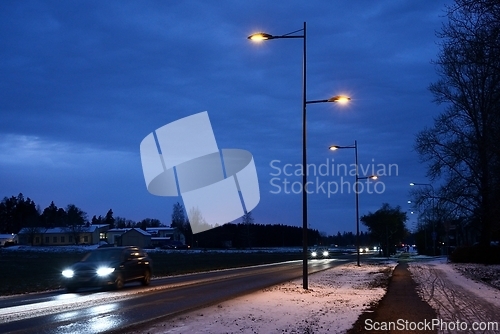Image of night traffic of cars on the road in a small Finnish town