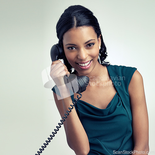Image of Portrait, smile and business woman on telephone in studio isolated on gray background. Face, landline or happy secretary on call for communication or receptionist listen to conversation on retro tech