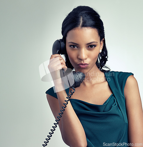 Image of Portrait, receptionist and business woman on telephone with person pouting in studio isolated on a gray background mockup. Face, landline and secretary on call for communication on retro technology