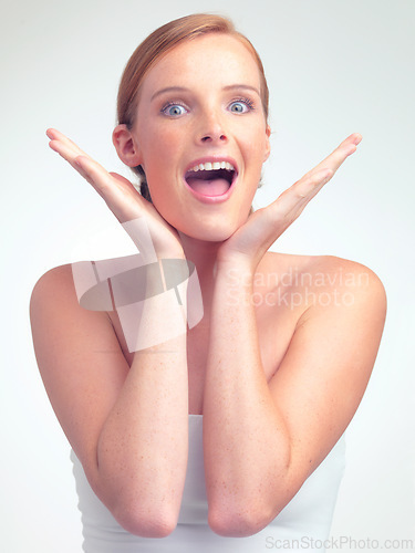 Image of Portrait, surprise and skincare of woman with beauty in makeup for glow, shine and wow in studio isolated on a white background. Face, hands and excited model with cosmetics for facial dermatology