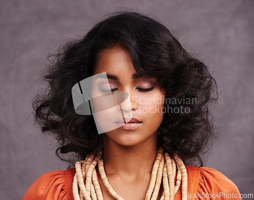 Image of Indian woman, face and fashion in studio with eyes closed on grey background with beauty and jewelry. Closeup, female person and makeup with traditional necklaces, outfit and heritage look.