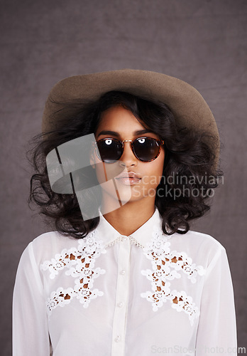 Image of Portrait, sunglasses and woman with cowboy fashion, confidence and relax with girl in stetson hat. Rodeo, western style and Mexican model with cowgirl culture, wild west clothes and grey background