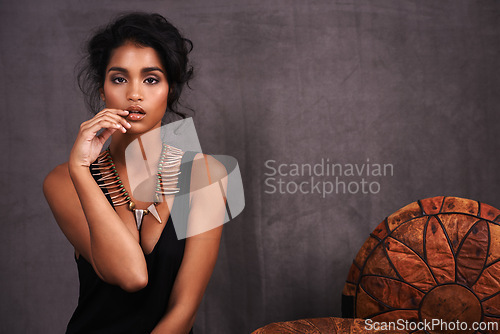 Image of Indian woman, confident and fashion in studio with jewelry on grey background with beauty and style. Portrait, female person and makeup with traditional necklaces, outfit and heritage look.