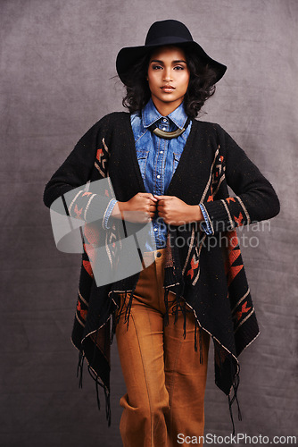 Image of Fashion, cowgirl or woman with confidence in portrait, studio or cool clothing in culture on grey background. Native American person, unique or stylish model with pride, boho style or western poncho