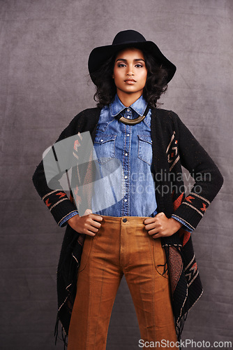 Image of Fashion, cowgirl or woman confidence in portrait, studio and cool culture or clothing on grey background. Native American person, western and stylish model with pride, boho style and hands on hips