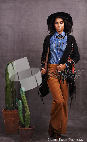 Image of Cactus, fashion or woman in cowgirl, portrait, wild west culture and cool clothes in studio on grey background. Native American person, western lady and stylish model with pride, boho style or plants