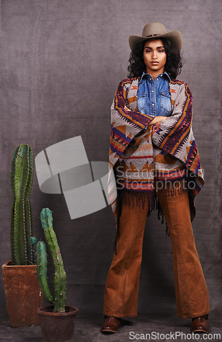 Image of Cactus, fashion or cowgirl in style, portrait, wild west culture or cool clothes in studio on grey background. Confident person, western woman or stylish model with pride, boho outfit or plants