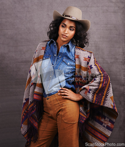 Image of Culture, cowgirl or woman thinking in studio, wild west and cool fashion or clothing on grey background. Native American person, western lady and stylish model with pride, boho style and confidence