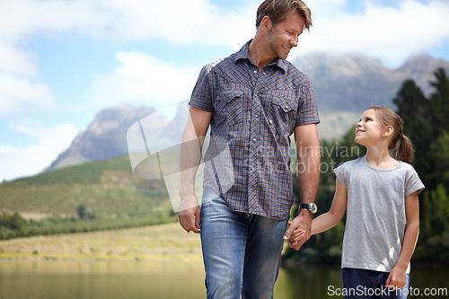 Image of Father, daughter and holding hands by a lake, bonding in nature or camping with holiday, travel and family time. Love, support and trust, man and young girl outdoor for adventure and fresh air