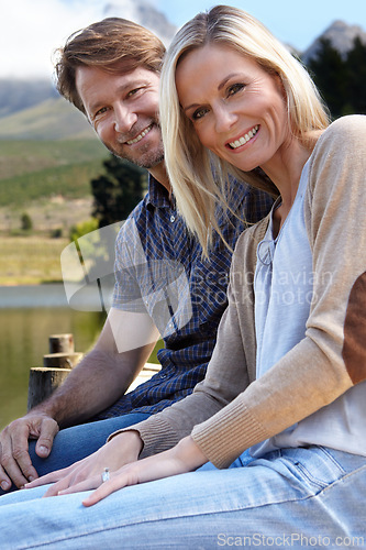 Image of Smile, relax and portrait of couple by lake in summer for vacation, holiday and bonding at countryside. Man, woman and happy for outdoor weekend adventure, travel and tourism with love in Europe