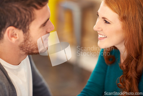 Image of Couple, smile and romance with eye contact in cafe, support and happiness for peace in relationship. Adult, woman and girl with love for man or partner in coffee shop and joy for marriage with guy