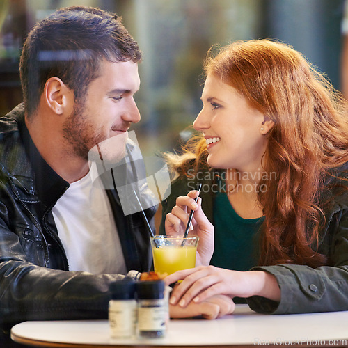 Image of Couple, holding hands and juice in cafe happy with smile, romance and affection on anniversary date. Romantic, man and woman in restaurant bonding with drink or beverage and joy in relationship