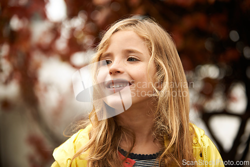 Image of Smile, thinking and happy girl in autumn, winter and outdoors for cold weather. Face, child and joyful in winter season or rain on vacation in Scotland, holiday or outside for freedom or travel