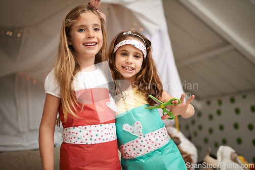 Image of Style, paper and portrait of children with dress for fun, show or playing together at home. Happy, smile and young girl kids in gift wrap outfit for fashion with bonding in bedroom at house.