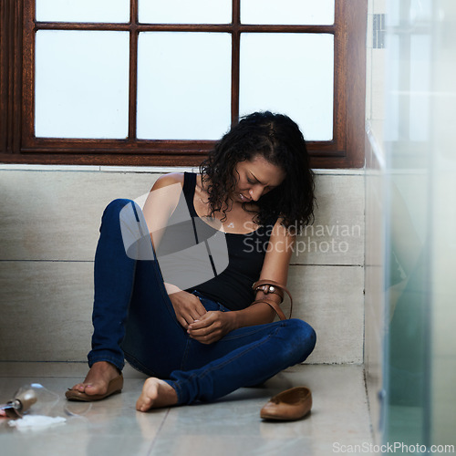 Image of Woman, drug addict and overdose in bathroom for addiction or withdrawal symptoms, depression and mental health. Person or user, relapse and belt for heroin or substance abuse for feeling of euphoria