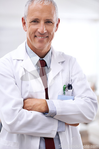 Image of Healthcare, portrait and medical professional with arms crossed in hospital for support, services and wellness. Medicine, surgeon and happy mature male doctor for confident, smile and treatment