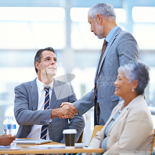 Image of Coworker, office and handshake with deal for success in business, contract and teamwork. Diverse, boardroom and smile for meeting achievement with congratulations as ceo or leader of company.