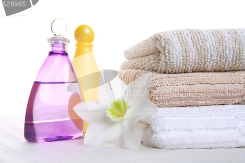 Image of aromatic oil, shampoo and towel