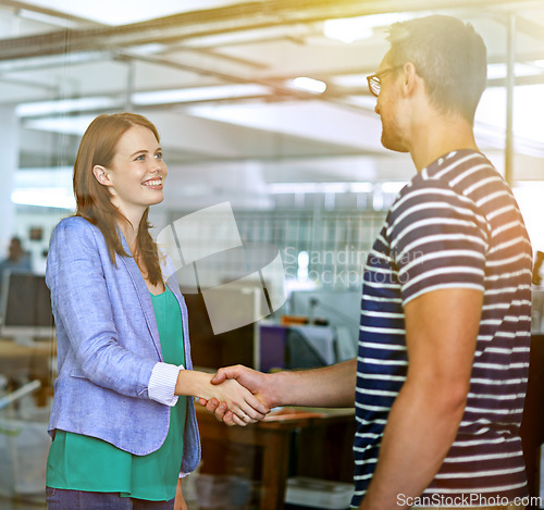 Image of Business people, shaking hands and smile for interview or agreement, thank you and partnership in recruitment. Colleagues, onboarding and introduction in creative agency, deal and negotiation at work