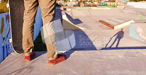 Image of Man, legs and skateboard for hobby at skatepark with practice or training to play, trick and committed. Closeup, exercise and experience on break or leisure to enjoy for activity, sport and fitness