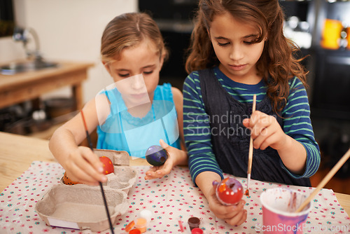 Image of Painting eggs, sisters and home with girls, creative and hobby with recreation and artistic. Youth, siblings and kids with child development and happiness with tools and colour with activity or relax
