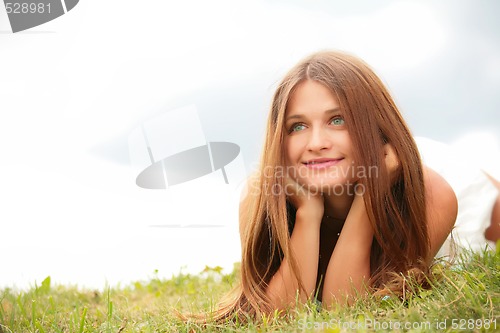 Image of girl lying on green herb