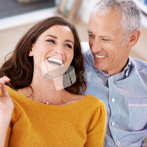 Image of Couple, happiness and laughing on sofa for love with support, trust and comic joke in living room of house. Senior man, woman and funny in home with embrace, affection and relationship in apartment