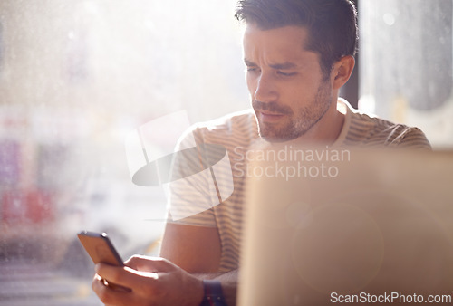 Image of Man, restaurant and phone or laptop, communication and website for information. Male person, freelancer and app for conversation, social media and remote work in coffee house for internet research