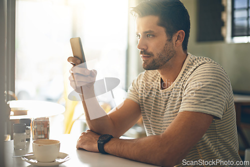 Image of Man, relax at coffee shop with smartphone and scroll online for social media, tech and communication. Chat, reading on mobile app or ebook with break at cafe, contact and using phone with network