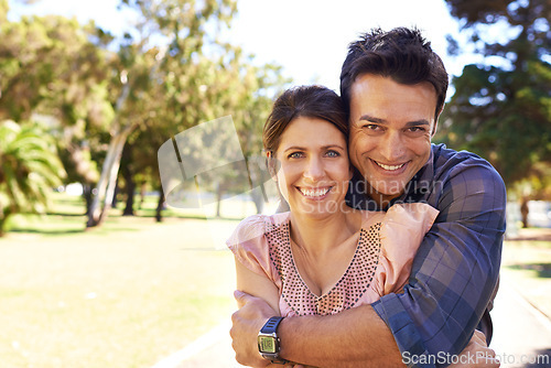 Image of Couple, portrait and happiness at park with hug for bonding, relax and summer date outdoor in Amsterdam. Man, woman and face with smile in nature with healthy relationship, anniversary and embrace