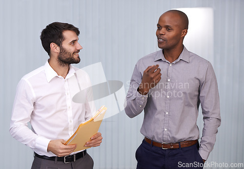 Image of Men, paper or smile in office, conversation or exchange of idea for support, trust or networking. Businessmen, document or happy to talk, discuss or explain for professional, corporate or project