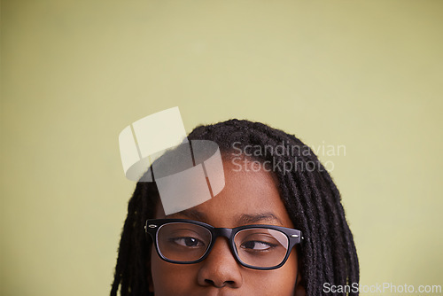 Image of Glasses, vision and boy kid with cross eyes in studio for eye care, testing or optometry on green background. Medical, help and black teen model with eyeball correcting lens, prescription or solution