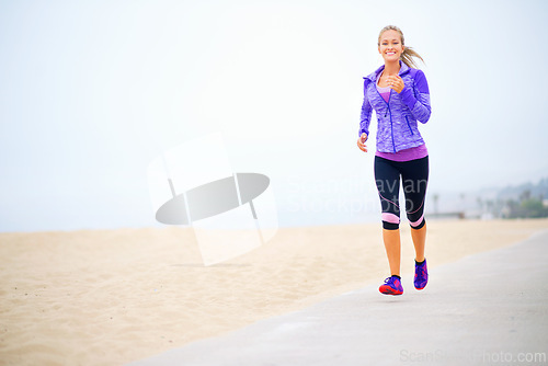 Image of Portrait, space or happy woman at beach running for exercise, training or fitness workout at sea. Sports person, runner and healthy female athlete on road for cardio endurance, wellness and mockup