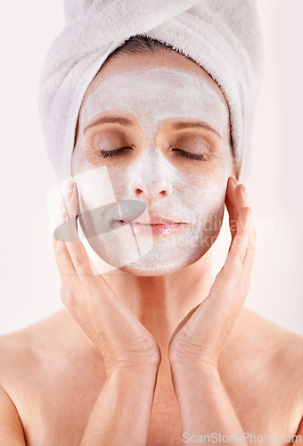 Image of Face, mask or woman in studio for facial or skincare routine with natural detox or cosmetics with towel. Model, spa or female person with lotion for anti aging treatment or beauty on white background