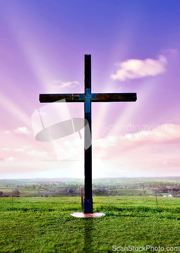 Image of christian cross at sunset or sunrise
