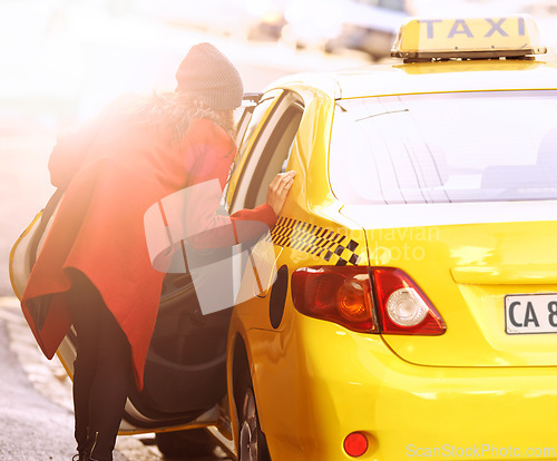 Image of Woman, cab and taxi for transport, commute and car for vehicle, passenger and move for traffic in urban. Young person and open door for lift, ride and drive in street or sidewalk with sun flare