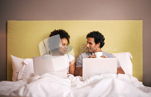 Image of Bedroom, laptop and couple with smile for working from home in apartment, love and writers for romance. Partners, woman and man on bed of house with technology for career and coffee in morning