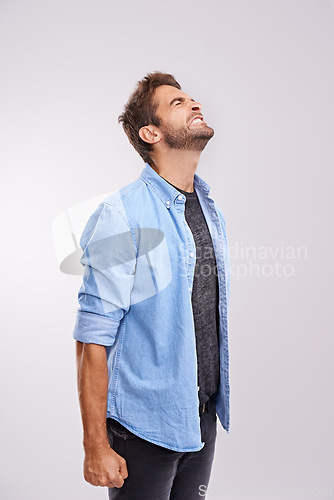 Image of Upset, angry and frustrated with man, stress and facial expression on a grey studio background. Body language, person and model with emotions and burnout with anxiety and anger with crisis or mistake