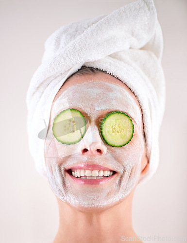 Image of Spa, mask or woman with cucumber facial, skincare in studio with natural detox, smile or cosmetics. Happy model, confidence or face with lotion for anti aging treatment or beauty on white background