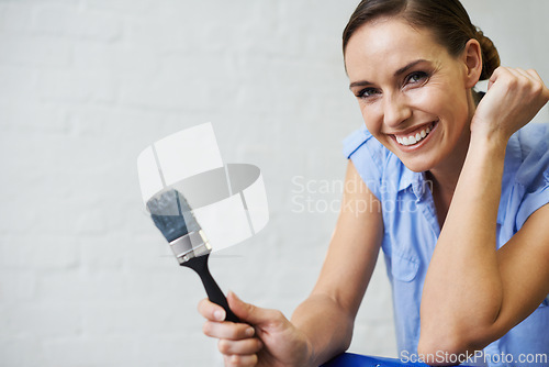 Image of Woman, portrait and brush for paint in home, remodeling and fixing in apartment. Happy female person, smile and equipment for project upgrade, do it yourself and tool for house repairs or project