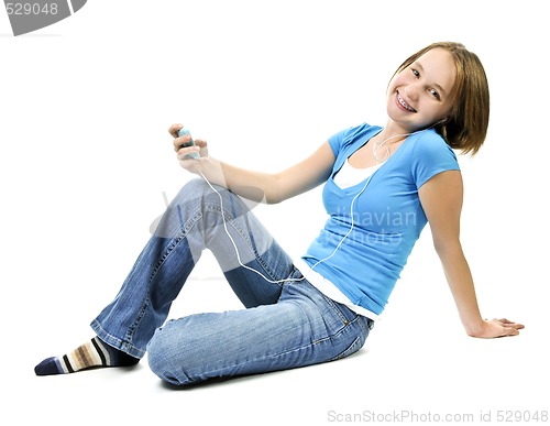 Image of Teenage girl listening to music