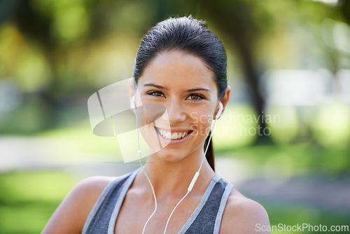 Image of Park, fitness and portrait of woman with earphones for exercise, training and cardio music. Athlete person, smile and headphones with happiness for audio streaming, podcast and healthy body workout